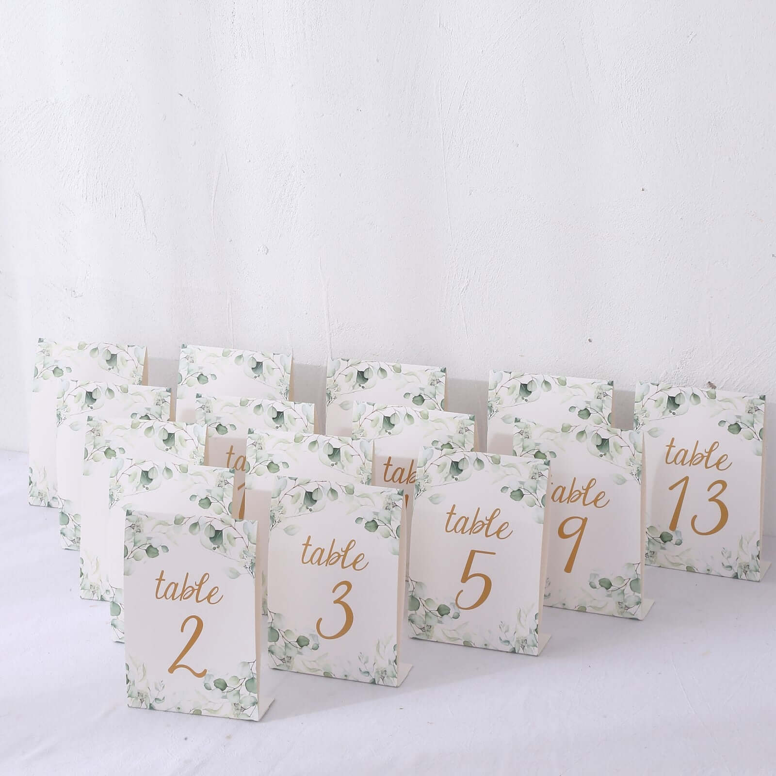 25-Pack Paper Wedding Table Numbers 1-25 White/Green Eucalyptus Leaves Design - Free Standing Double Sided Table Signs with Glam Gold Foil Numbers 7"